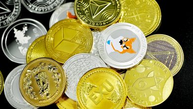 Different forms of crypto coins on a table.