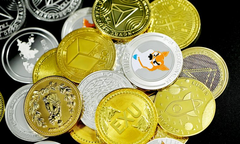 Different forms of crypto coins on a table.