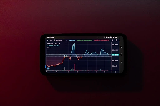 Phone showing a trading graph