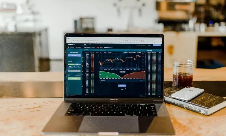 photo showing stock charts on a laptop